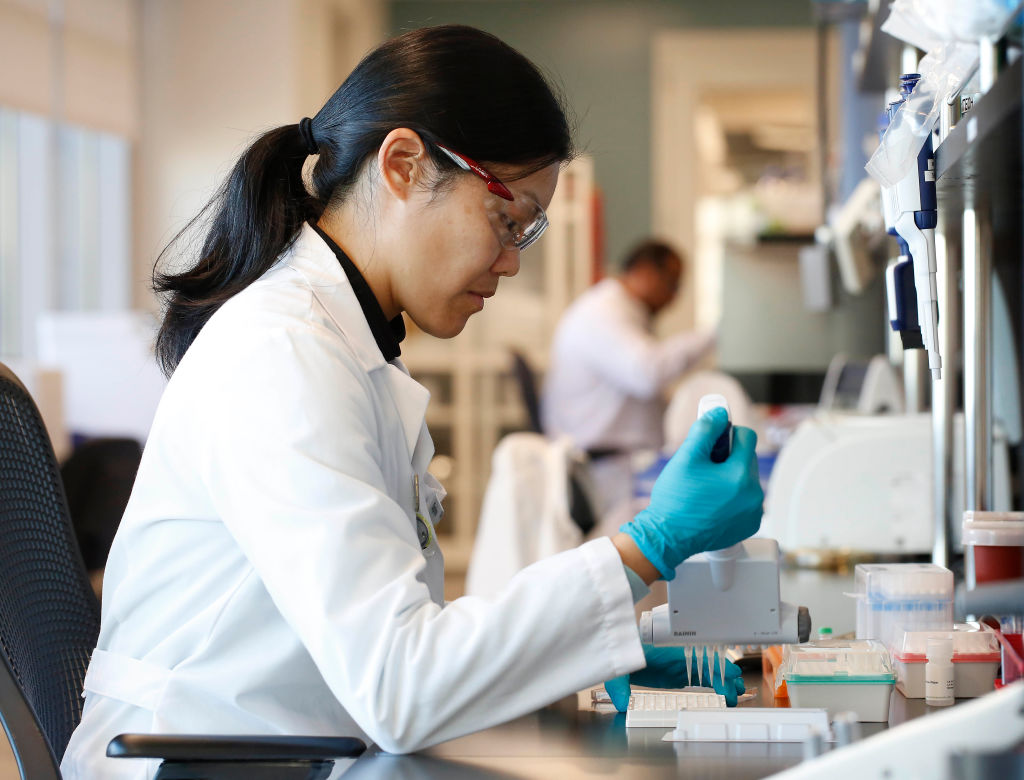 Daphne Ma, research scientist in†the microbiology group, performs an enzyme-linked immunosorbent assay (ELISA) to determine the number of antibodies in a particular sample in the†biology laboratory.