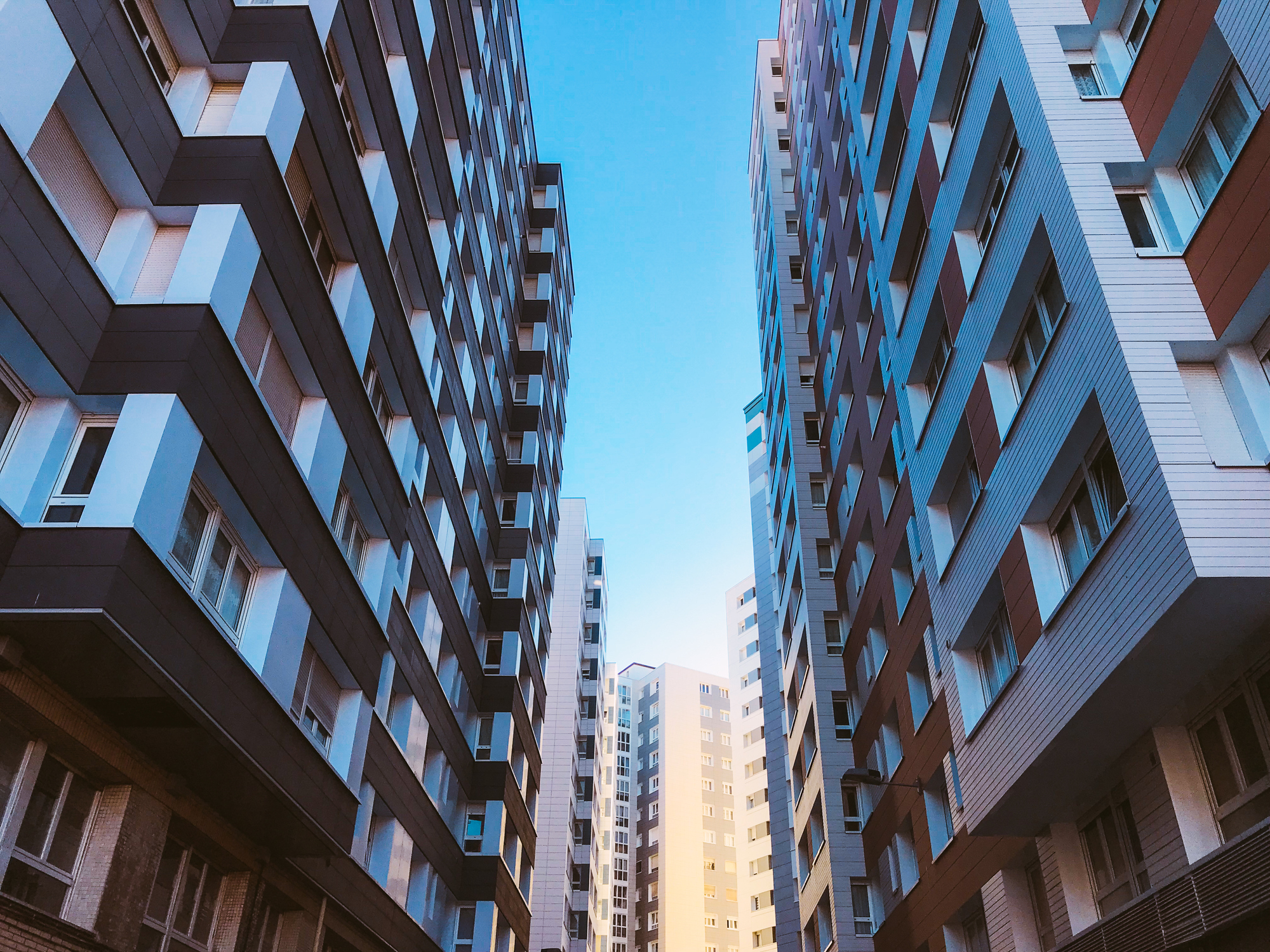 Low angle view of residential buildings against blue sky
