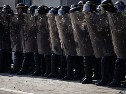 A squad of police stand on guard during the demonstration