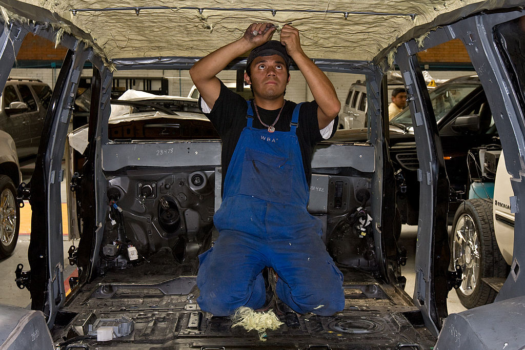 A worker prepares a vehicle for armor in the AutoSafe factor