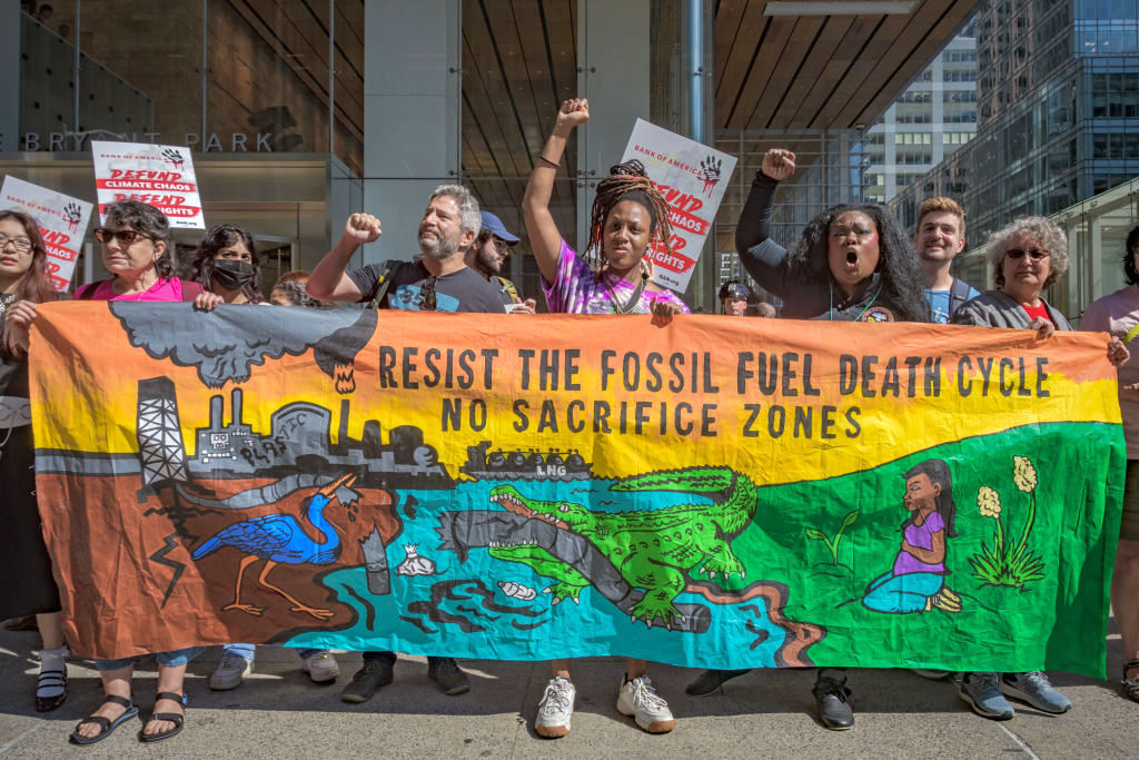 Participants seen holding a banner at the protest. Ahead of