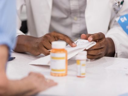 Unrecognizeable people at the pharmacy counter