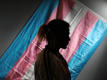 Charlotte stands for a portrait at El/La Para TransLatinas in front of a transgender pride flag on Wednesday, January 22, 2019 in San Francisco, Calif.