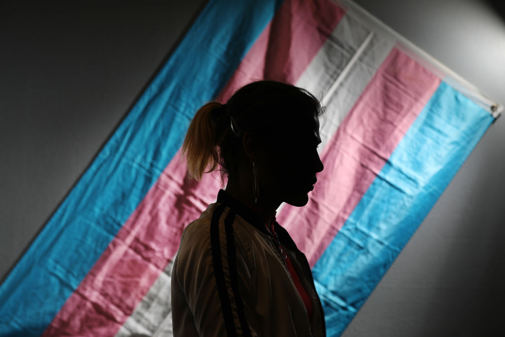 Charlotte stands for a portrait at El/La Para TransLatinas in front of a transgender pride flag on Wednesday, January 22, 2019 in San Francisco, Calif.