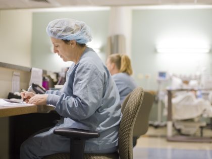 Nurses at their station prepare paperwork