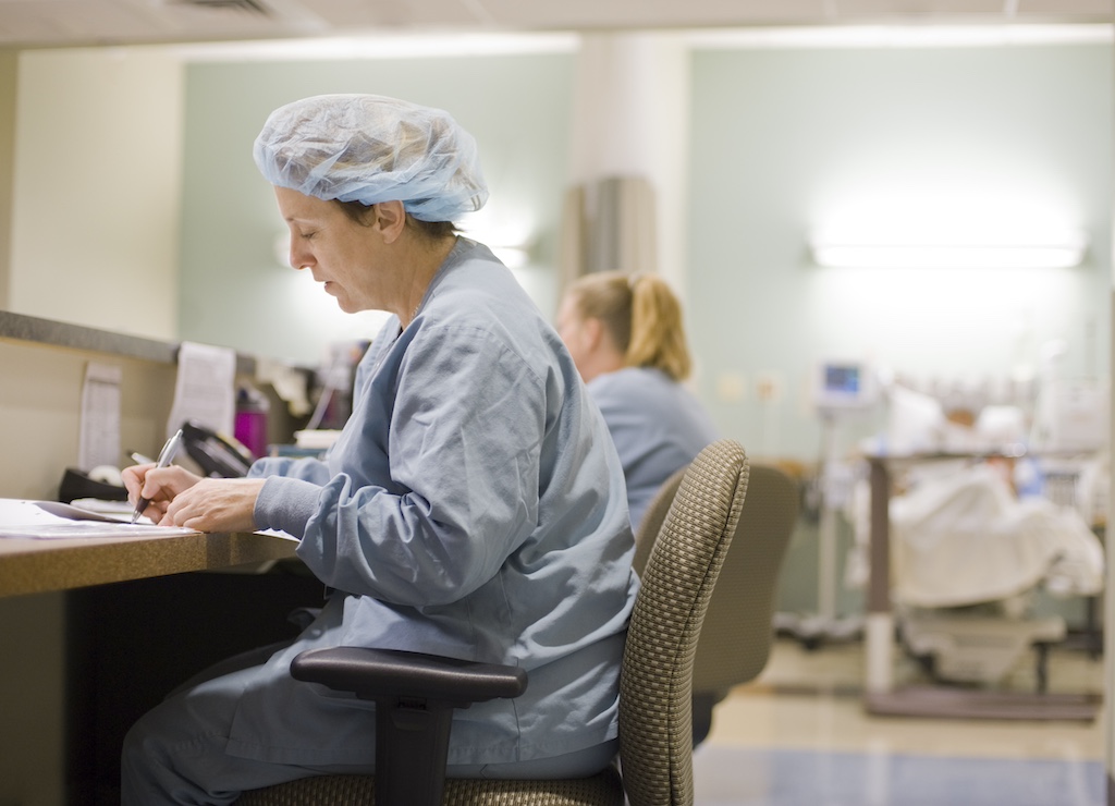 Nurses at their station prepare paperwork