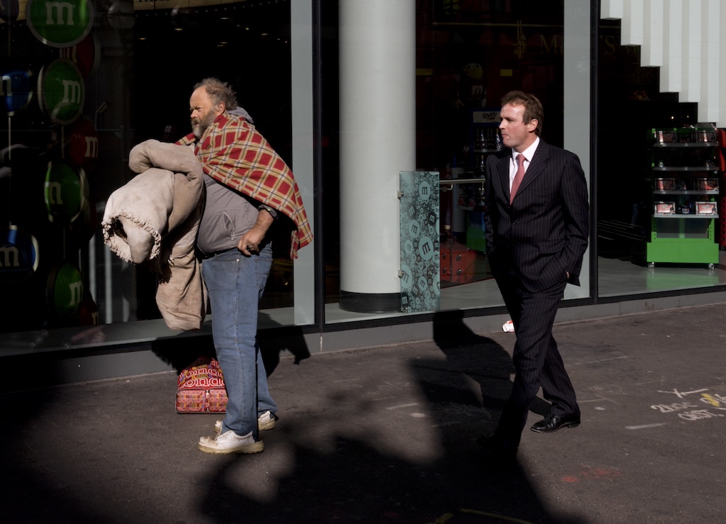 UK - London - Homeless man and businessman in street sunshine