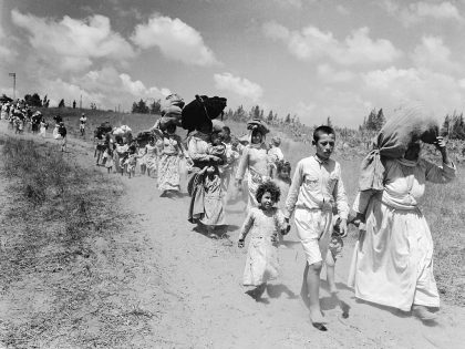 Women and Children Carrying Their Possessions