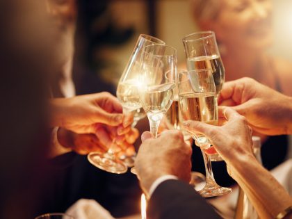 Success, hands or toast in a party for goals, winning deal or new year at luxury social event celebration. Motivation, team work or people cheers with champagne drinks or wine glasses at dinner gala