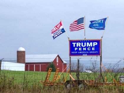 A Trump-Pence re-election sign and flags are displayed along