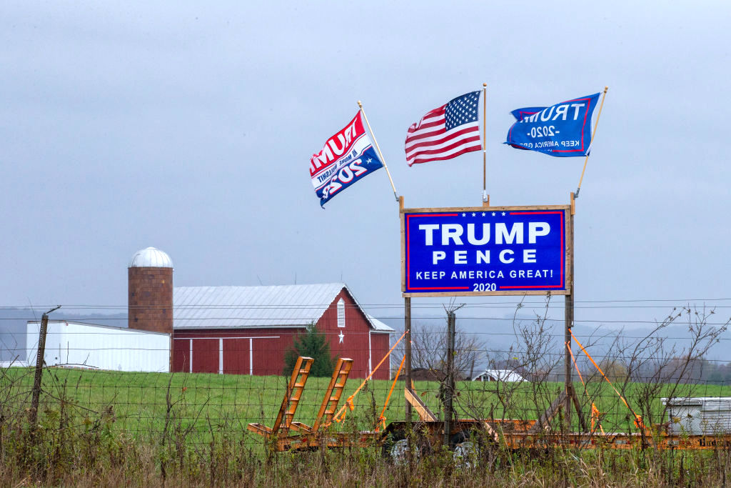 A Trump-Pence re-election sign and flags are displayed along