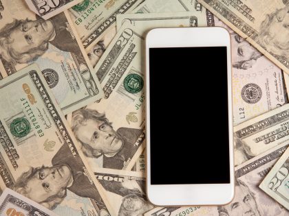Smart Phone Laying On Money