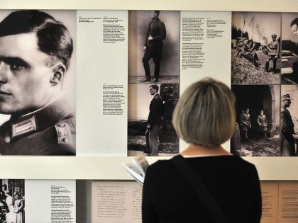 A visitor looks at pictures of Claus Sch