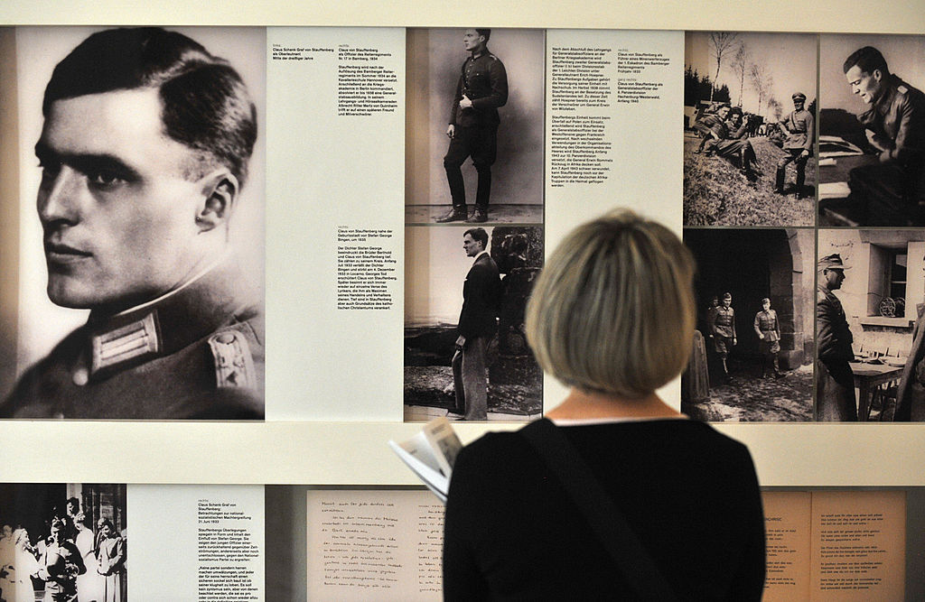 A visitor looks at pictures of Claus Sch