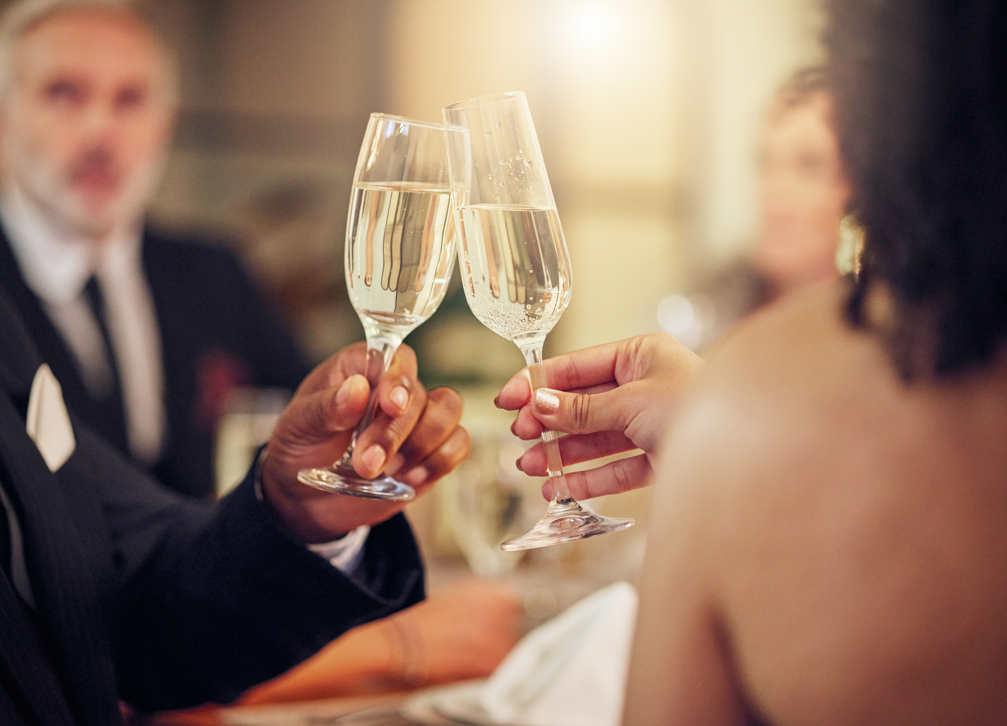 Success, hands or champagne toast in a party in celebration of goals, achievement or new year at luxury event. Motivation, congratulations or friends cheers with drinks or wine glasses at dinner gala