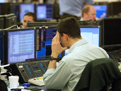 Analysts work on the trading floor at Go