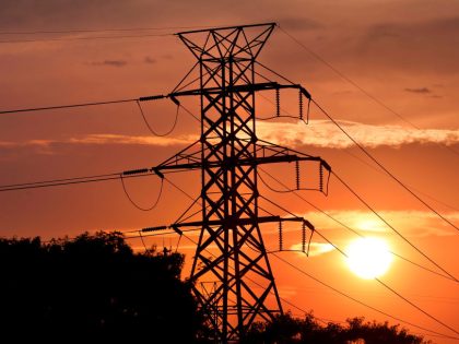 Tower carrying PSEG Long Island transmission lines silhouette the setting sun