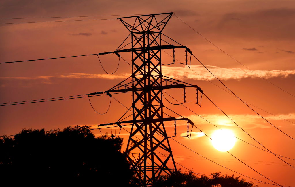 Tower carrying PSEG Long Island transmission lines silhouette the setting sun