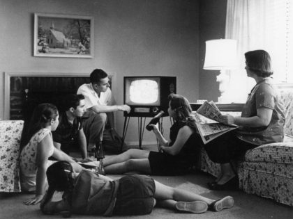 Family Watching Television At Home