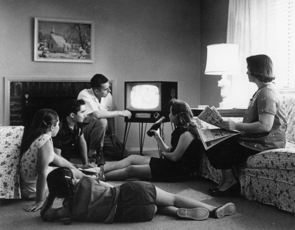 Family Watching Television At Home