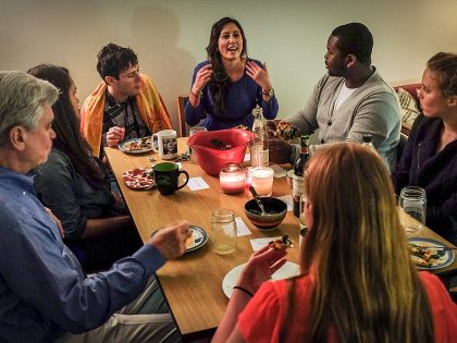 Georgetown univesity tudents and a professor meet for dinner and to get to know each other, in Washington, DC.