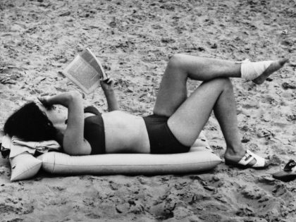 Woman Reading on a Beach