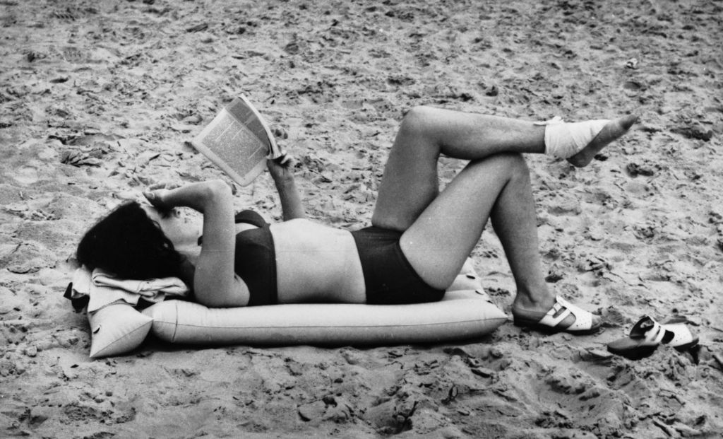 Woman Reading on a Beach