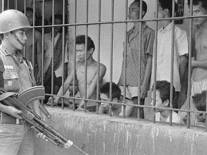 Soldier Watching over Suspected Communist