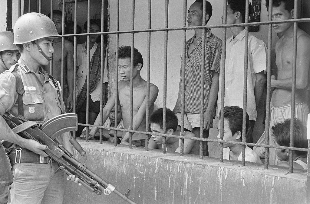 Soldier Watching over Suspected Communist