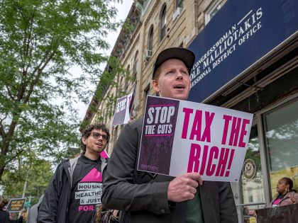 Participant seen holding a sign at the protest. New Yorkers