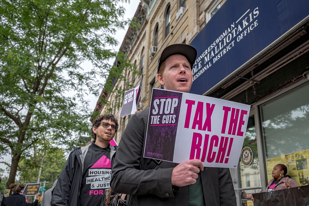 Participant seen holding a sign at the protest. New Yorkers