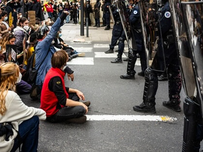The front of the procession featuring a high school student and protesters sitting facing law enforcement officers in downtown Perpignan in the Pyrénées-Orientales department in southern France on October 24, 2026.