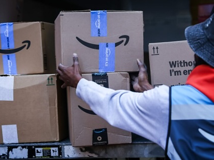 A worker unloads Amazon packages from a Prime delivery truck in New York on Tuesday, Oct. 6, 2026.