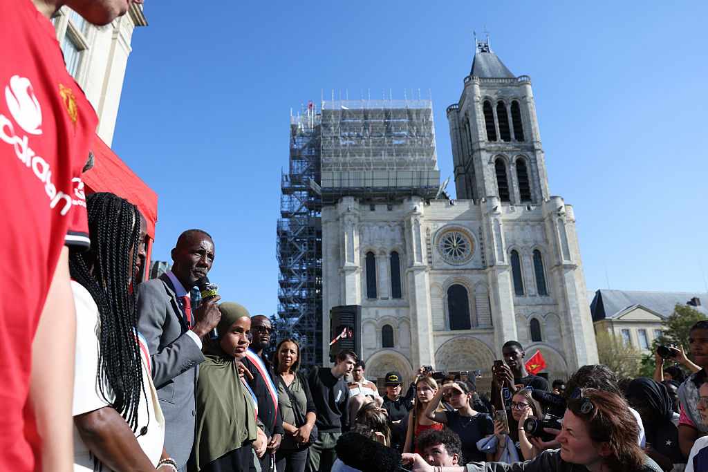 The mayor of Saint-Denis Bally Bagayoko addresses students near the cathedral in Saint-Denis.