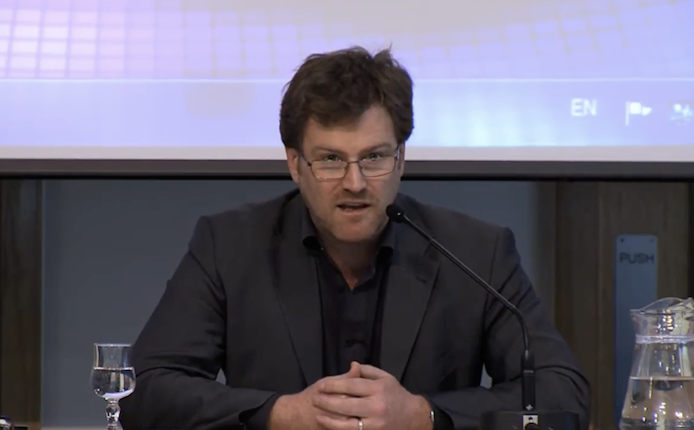 Peter D. Thomas delivers remarks at an academic event.