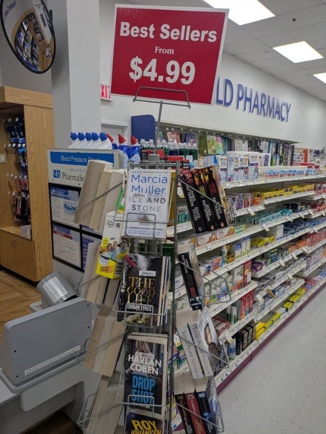 A spinner rack in a Canadian drugstore, July 2026 