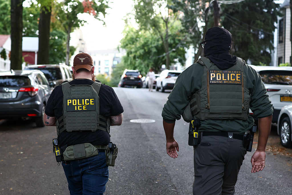 Federal agents walk near the scene where a man was shot by an Immigration and Customs Enforcement (ICE) officer during an operation in the Bronx borough of New York on October 8, 2026.