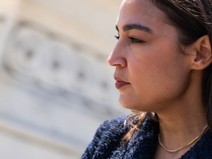 Alexandria Ocasio-Cortez talks with reporters outside the US Capitol after the last votes of the week on June 25, 2026.