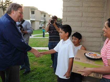 Rev. Rick Warren hands out food in his Orange County, California community.