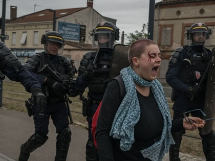 An injured protester screams in front of CRS riot police as high school students demonstrate countrywide over what they denounce as poor learning conditions, near the Lycée Polyvalent Déodat de Séverac in Toulouse, southwestern France, on October 1, 2026.