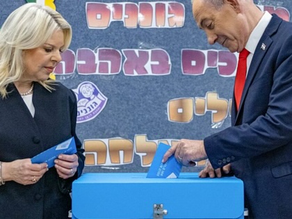 Benjamin Netanyahu casts his ballot, next to his wife Sara, at a polling station in Jerusalem on October 27, 2026, on the day of Israel's legislative election.