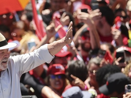 Brazilian President Luiz Inácio Lula da Silva greets supporters as he attends a campaign rally ahead of the runoff election, in Brasilia, on October 9, 2026.
