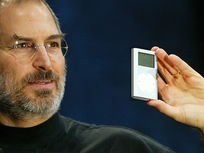 Apple CEO Steve Jobs holds a new mini iPod at Macworld January 6, 2004, in San Francisco. Jobs announced several new products including the new iLife 4 software and the Mini iPod.