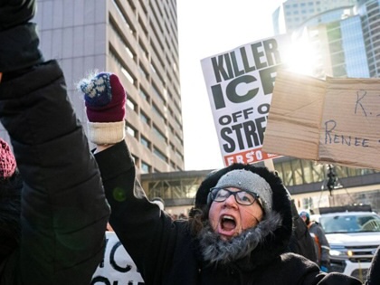 A crowd of protesters against Immigration and Customs Enforcement (ICE) march through the streets of downtown Minneapolis, Minnesota, on January 25, 2026.