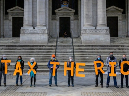 Participants seen spelling out #TaxTheRich at the New York Public Library in Manhattan, on March 4, 2021.