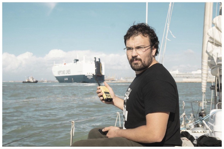 Luca Poggi of the Global Sumud Flotilla aboard a sailboat in Livorno’s harbor, with a handheld radio. October 20, 2026.