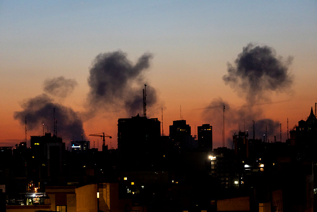 A skyline view shows smoke rising from a March 6, 2026 airstrike in Tehran. 