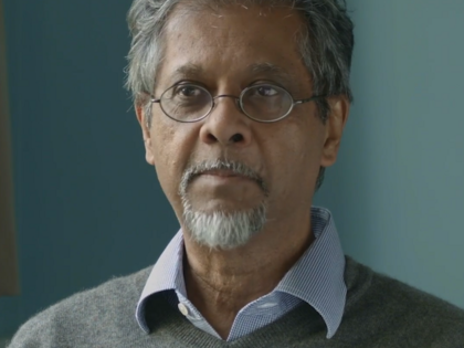 A still of a filmed interview with Marxist economist Anwar Shaikh, conducted in the Fall of 2016