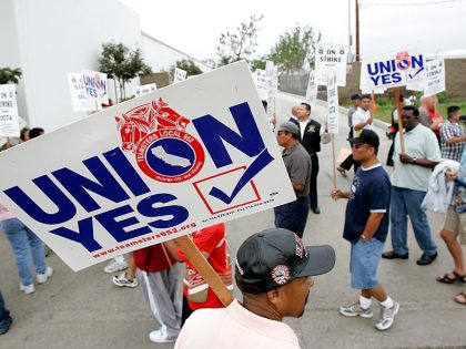 Members of the coach operators' union picket outside an OCTA bus yard as negotiations between the s