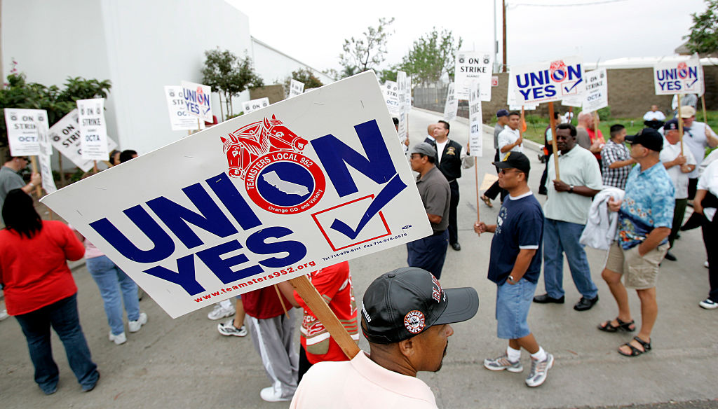 Members of the coach operators' union picket outside an OCTA bus yard as negotiations between the s